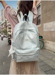 Light blue star pattern backpack for women and students, casual daily travel school bag with pocket.