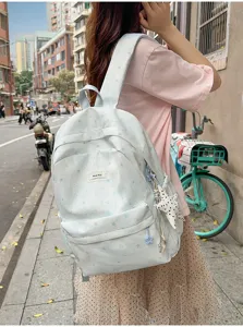 Light blue star printed canvas backpack for women, stylish student school bag for daily travel.