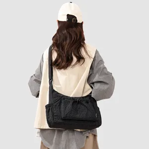 Checkered messenger bag with front drawstring pocket, casual daily single-shoulder bag for outdoor.