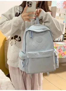 Light blue quilted backpack detail view featuring soft material and chic daily style.