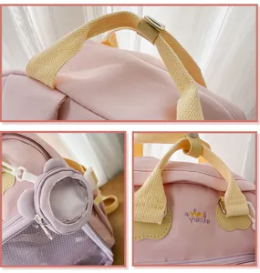 Detail shot of cute Japanese ins pink Ita backpack featuring transparent badge pocket and embroidery.
