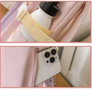 Pink backpack side pocket detail showing bottle holder and zipper compartment for phone.