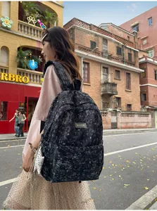 Black star pattern canvas backpack for women, casual school bag, travel daypack, chic style.