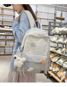 Detail view of the sweet star pattern backpack with cute plush charms and soft fabric.