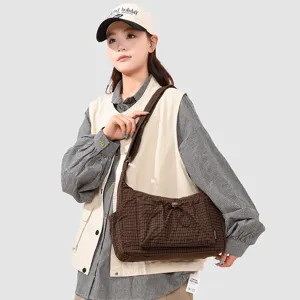 Brown plaid underarm shoulder bag with front drawstring pocket, stylish outdoor mountain daily use.