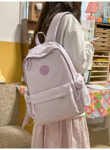 Detail view of the taro purple quilted backpack showcasing its texture and spacious pockets.