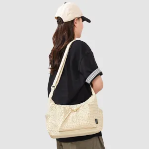 Beige canvas shoulder bag for women casual hobo bag with front drawstring pocket.