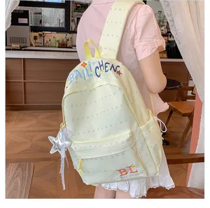 Zaino casual giallo chiaro con stampa di stelle per donne, borsa scolastica dolce con ciondolo.