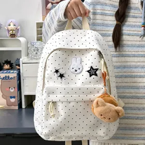 Japanese polka dot bunny backpack detail, cute canvas school bag with plush bear pendant.