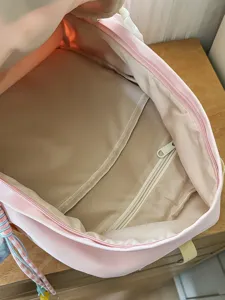 Kawaii pink student backpack interior view, cute daily school bag with inner pockets.