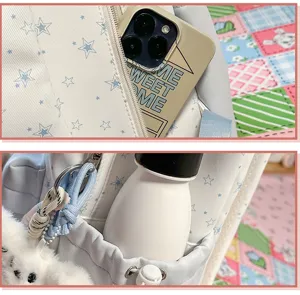 Close-up of the star embroidered sweet backpack showing front pocket and side storage design.
