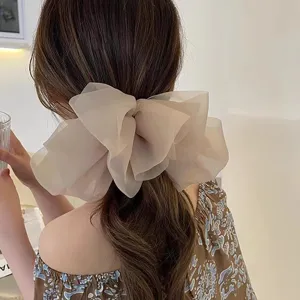 Elegant chiffon large bow hair clip detail shot, perfect for stylish ponytail styling.