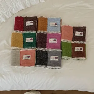 Detail view of colorful color-blocked knitted short scarfs, cozy winter neck warmer.