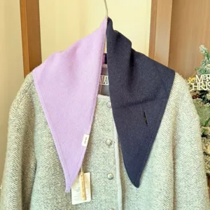 Detail d'echarpe triangulaire en tricot de laine, texture douce, design bicolore pour l'hiver.
