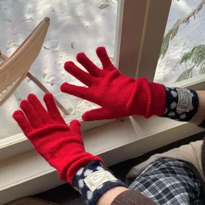 Détail rapproché de charmants gants en tricot rouge douillets avec de beaux poignets.