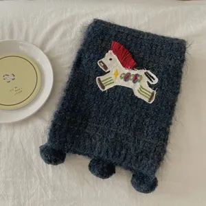 Cozy knitted winter scarf featuring cute embroidered pony design, soft fuzzy warm neck wrap.