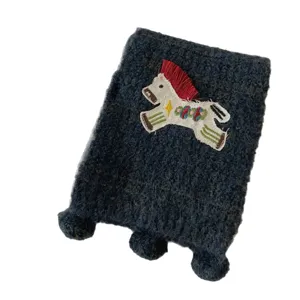 Knit scarf for women featuring cute embroidered horse design and pom-poms for winter warmth.