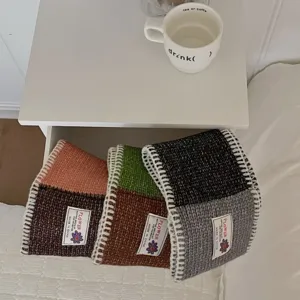 Detailed shot of color-block knitted neck warmer, wool blend short cross scarf in drawer.
