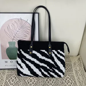 Sac cabas zébré en tricot avec poignées en cuir noir et fermeture éclair pour le quotidien.