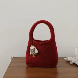 Red wool felt handbag detail with cute bird doll, mini tote bag for women and kids accessories.