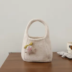 Beige knitted handbag with cute cartoon pig doll charm, stylish mini tote bag for women.