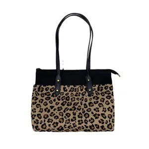 Sac cabas en tricot imprimé léopard avec poignées noires, fermeture éclair et style.