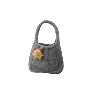 Grey knitted handbag featuring cute yellow cartoon felt doll, mini kids tote bag main image.