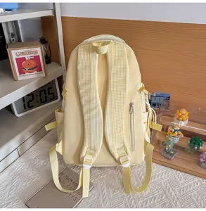 Yellow canvas school backpack with striped shoulder straps, cute casual daypack for daily use.