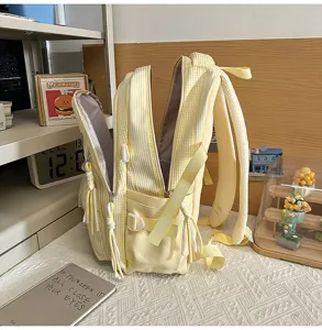 Detailed view of yellow white plaid school backpack with multiple compartments and pockets.