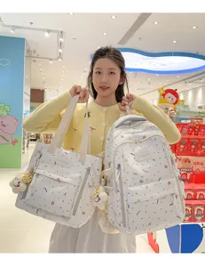 White canvas backpack and tote set with colorful star doodle print, casual school bag for girls.