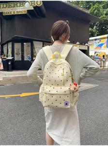 Zaino giallo a pois per donne, elegante borsa scolastica per viaggi e tempo libero quotidiano.