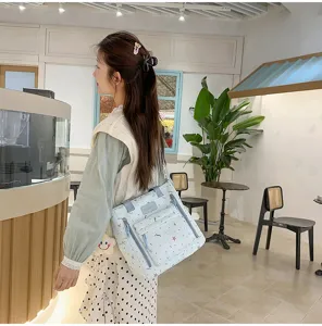Light blue casual backpack for women, Korean style student bookbag with cute abstract patterns.