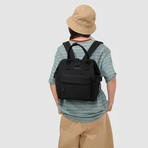 Vue arrière détaillée d'un sac à dos noir multi-compartiments porté par le modèle.