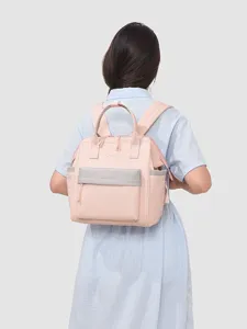 Sac à dos maman léger avec plusieurs compartiments pour soins de bébé et voyage.