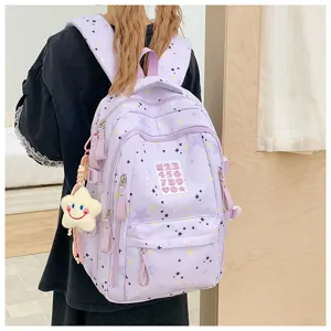 Cute star print student backpack detail view, large capacity casual daypack with charm.