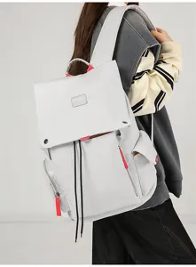 Grey multi-functional casual backpack detail showing flap design and red accent cords.