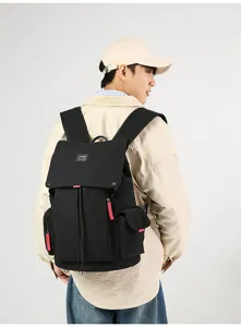Trendy black canvas backpack for men and women, large capacity travel school laptop bag.