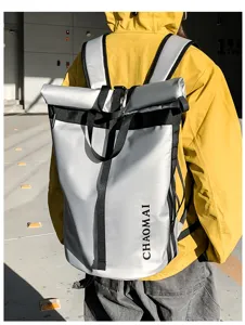 Detail view of the reflective roll-top backpack with durable black webbing straps.