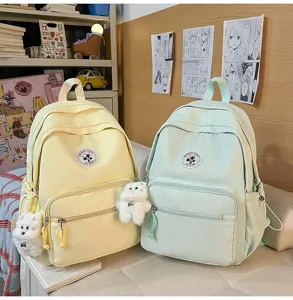 Zaino da scuola in tela per donna stile college morbido casual con ciondolo in peluche carino.