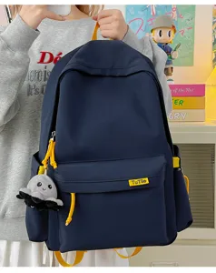 Casual nylon school backpack for students, stylish daily travel daypack with front pocket.