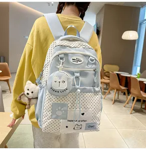 Detailed view of the cute polka dot school backpack with bear pendant and multi pockets.