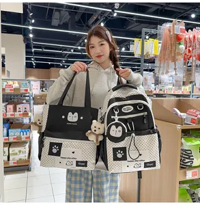 Detail view of Korean ins style polka dot backpack and tote bag set with cute bear pendants.