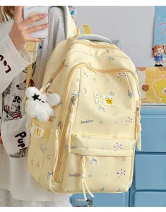 Korean style cute star pattern student school backpack detail view with fluffy bear pendant.
