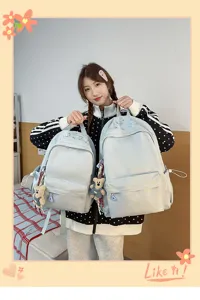 Detail view of the casual college student backpack with cute bear keychain and front pocket.