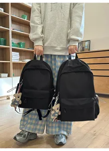 Casual black backpack for college students, stylish minimalist school bag for daily commute.