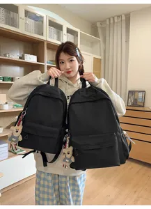 Classic black school backpack casual daypack with cute bear pendant for daily commute and travel