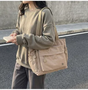 Casual large capacity commuter shoulder bag, lightweight canvas tote for women daily use.