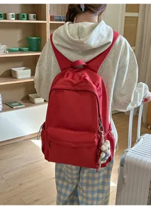 Red casual backpack for women, daily commute school bookbag with cute bear pendant.