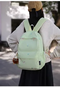Cute Japanese embroidered backpack for girls, light green school bag with tulip and rainbow motifs.