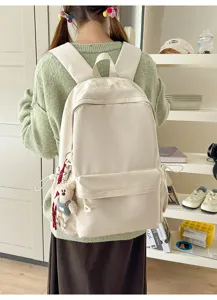 Casual solid color student backpack with cute bear pendant for daily commute and travel use